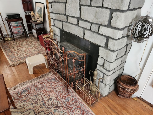 interior details with a fireplace and wood-type flooring