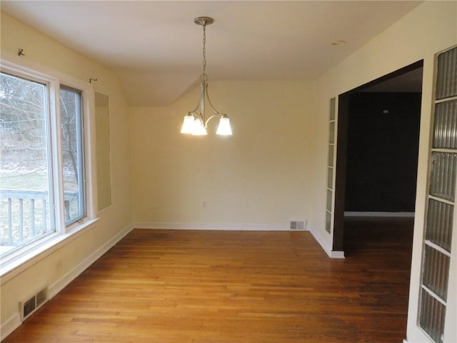 unfurnished dining area with a chandelier, light wood-type flooring, and visible vents