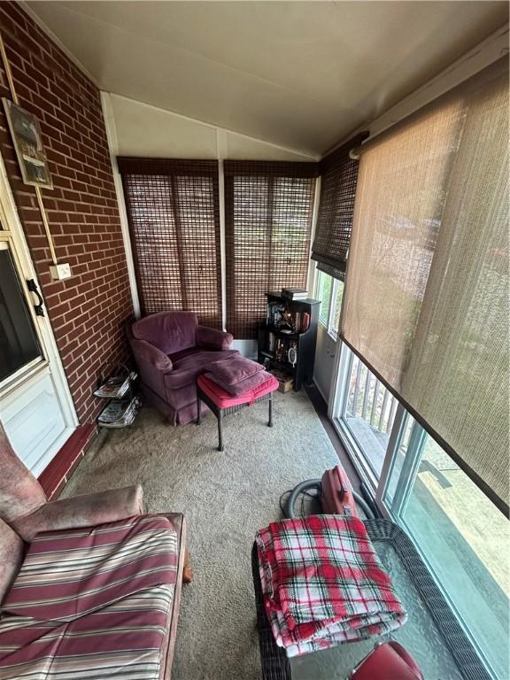 sunroom featuring lofted ceiling