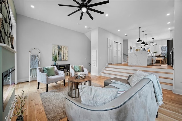 living room with ceiling fan and light hardwood / wood-style floors