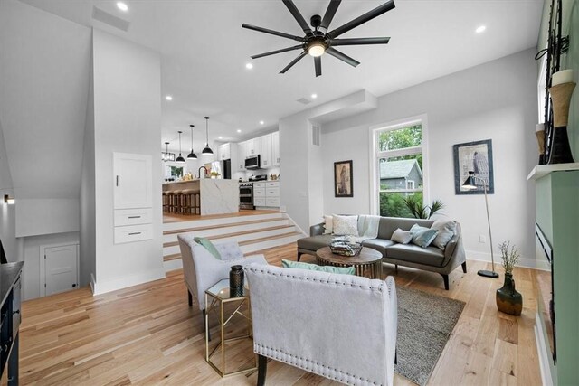 living room with ceiling fan and light hardwood / wood-style floors