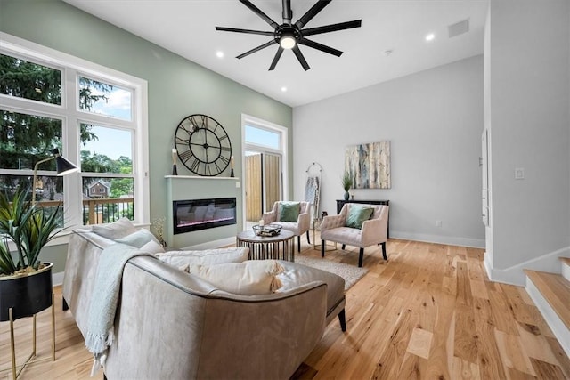 living room with ceiling fan and light wood-type flooring