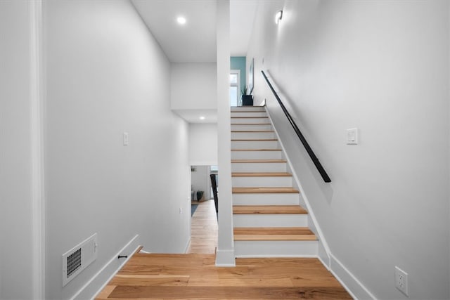 stairway featuring hardwood / wood-style floors