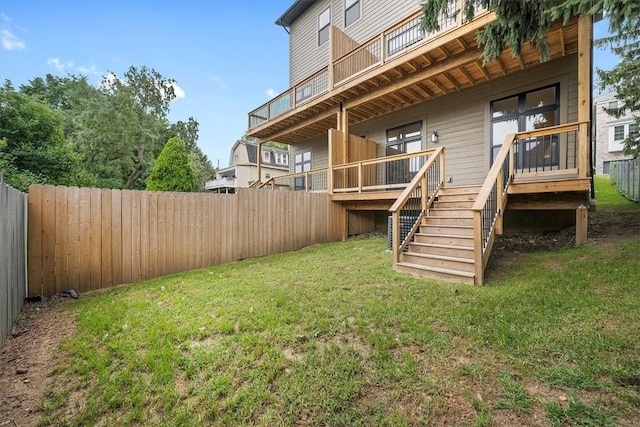 rear view of house featuring a yard