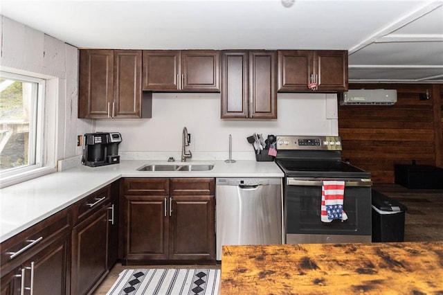 kitchen with light countertops, dark brown cabinetry, stainless steel appliances, and a sink