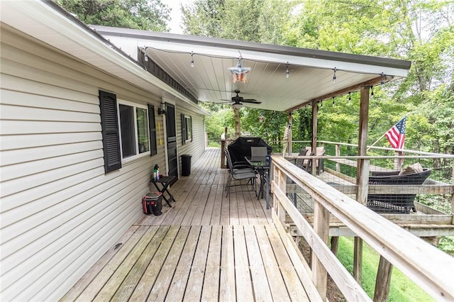 deck featuring outdoor dining space and ceiling fan