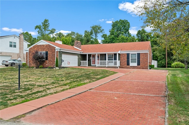 single story home featuring a garage, a front lawn, and covered porch