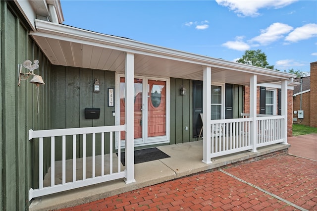 view of exterior entry with a porch