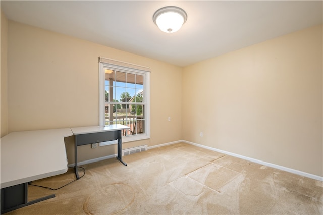 unfurnished office featuring light colored carpet