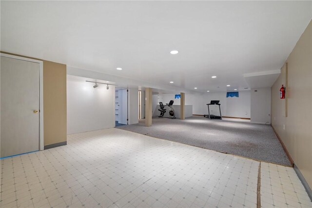 basement featuring light carpet