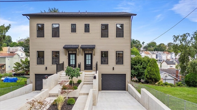 view of front of home featuring a garage and a front yard