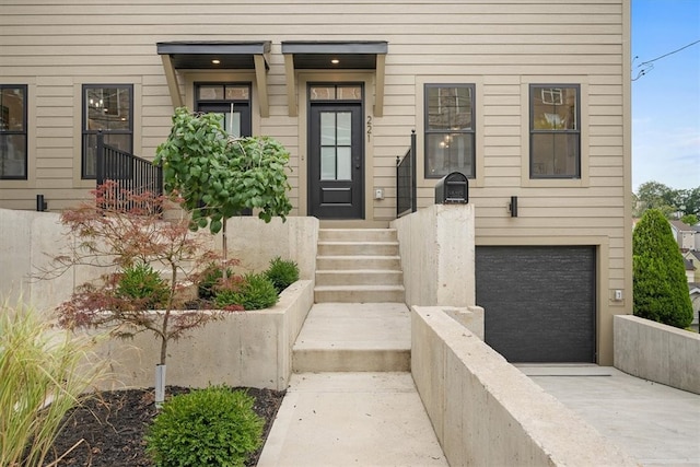 view of exterior entry with a garage