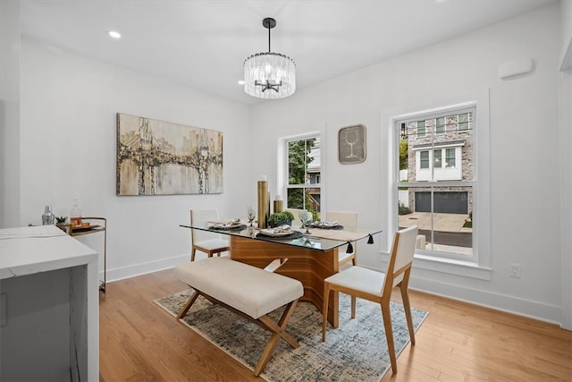 dining room featuring light hardwood / wood-style floors and a chandelier