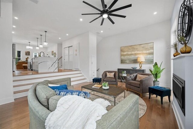 living room featuring hardwood / wood-style flooring and ceiling fan