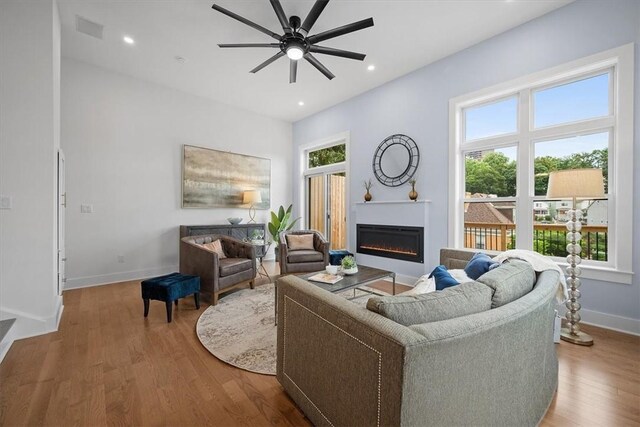 living room featuring hardwood / wood-style floors, a wealth of natural light, and ceiling fan