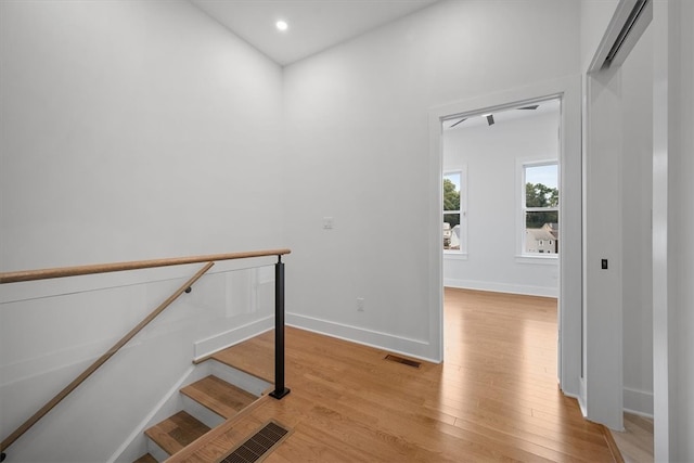 stairs featuring hardwood / wood-style floors