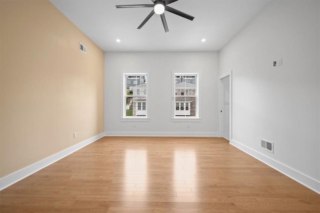 unfurnished room with light wood-type flooring and ceiling fan