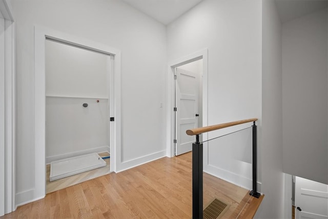 corridor with light wood-type flooring