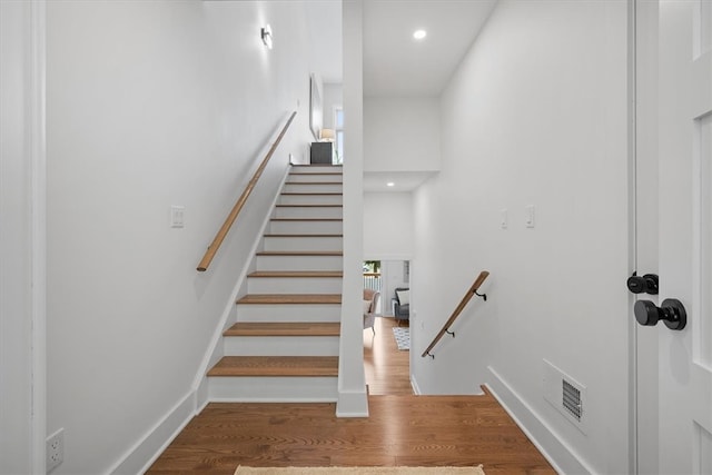 stairs with hardwood / wood-style floors