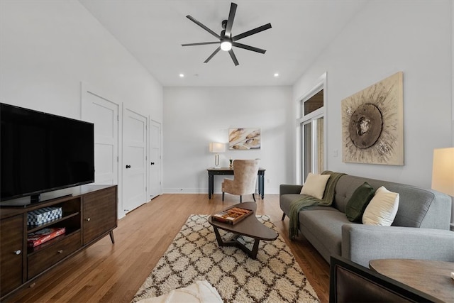 living room featuring light hardwood / wood-style floors and ceiling fan