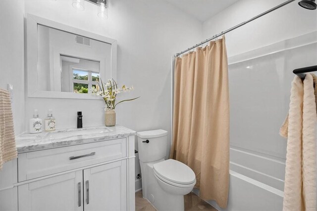 full bathroom featuring toilet, vanity, and shower / bath combo with shower curtain