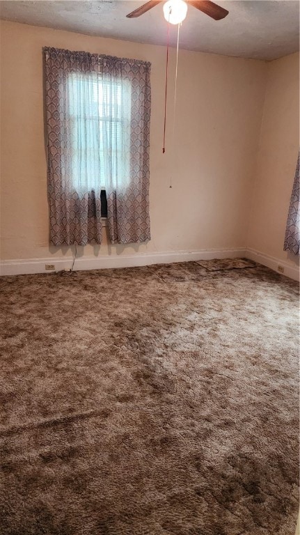 unfurnished room with carpet floors, ceiling fan, and a textured ceiling