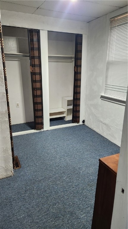 unfurnished bedroom with carpet and a drop ceiling