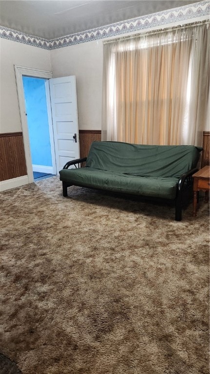 bedroom with wooden walls and carpet