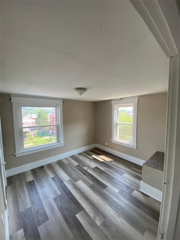 unfurnished room featuring dark hardwood / wood-style floors