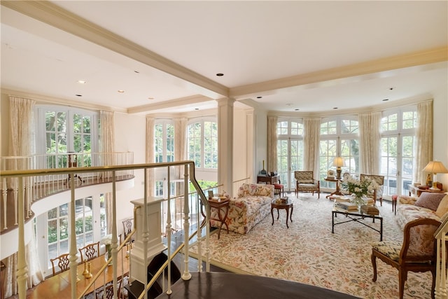 living room with a wealth of natural light, carpet, and crown molding