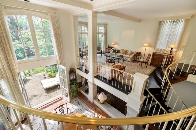 interior space with a wealth of natural light, a high ceiling, and decorative columns