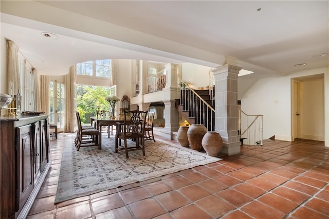 dining room with tile patterned flooring and decorative columns