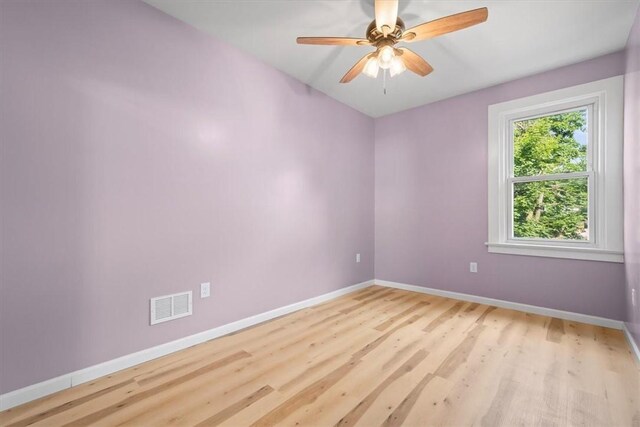 empty room featuring ceiling fan and light hardwood / wood-style floors