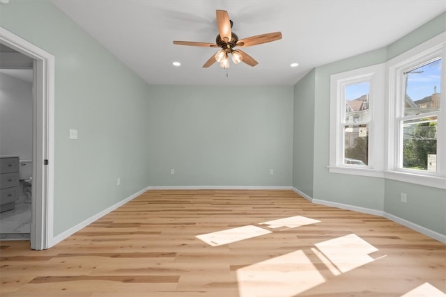 spare room with ceiling fan, light hardwood / wood-style flooring, and a healthy amount of sunlight