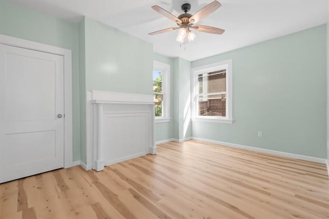 spare room featuring light wood-type flooring and ceiling fan