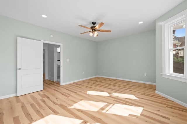 empty room featuring light hardwood / wood-style floors, plenty of natural light, and ceiling fan