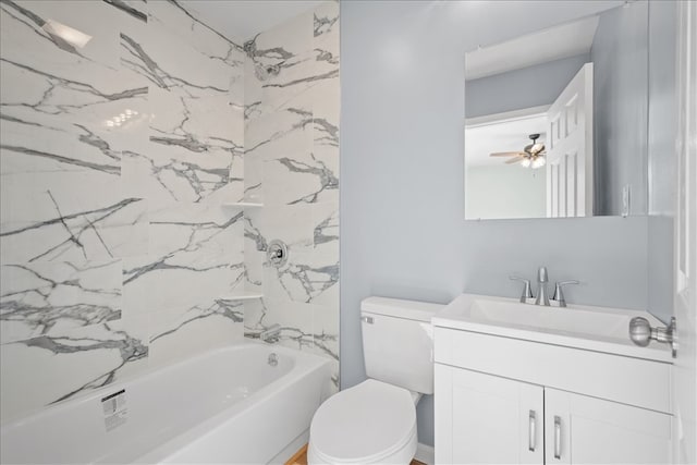 full bathroom featuring ceiling fan, toilet, tiled shower / bath, and vanity