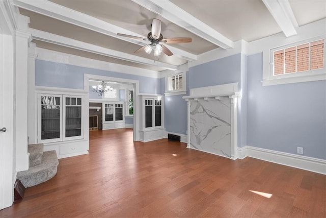 unfurnished living room with beam ceiling, ceiling fan with notable chandelier, and hardwood / wood-style floors