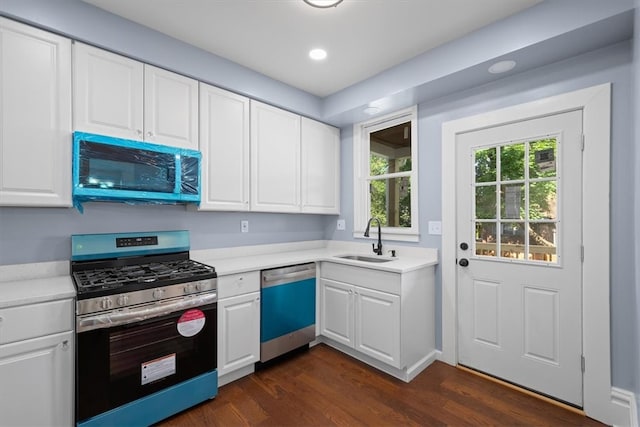 kitchen with dark hardwood / wood-style flooring, white cabinets, sink, and appliances with stainless steel finishes