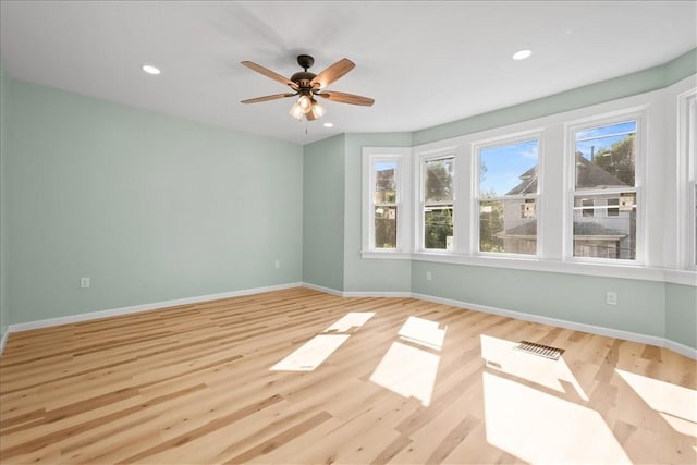 spare room with ceiling fan and light hardwood / wood-style floors