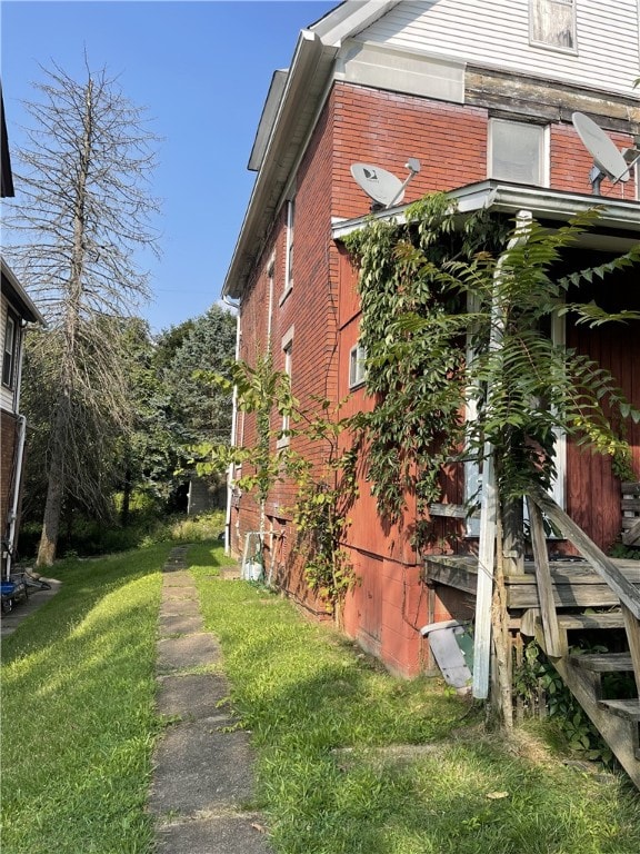 view of home's exterior with a lawn