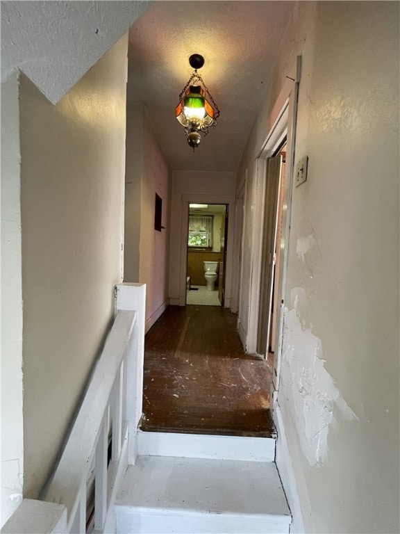 hall with a textured ceiling