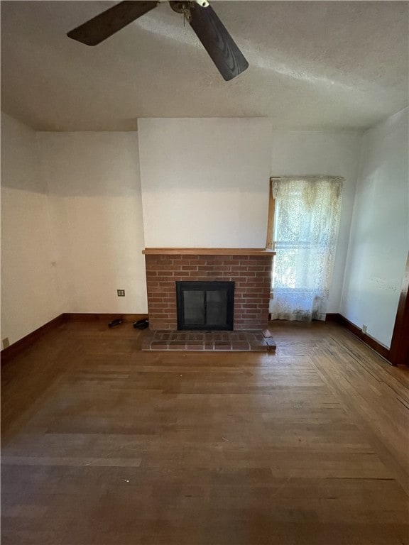 unfurnished living room featuring ceiling fan, a fireplace, and a textured ceiling