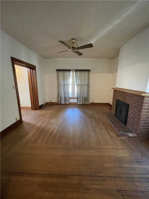 unfurnished living room with ceiling fan, dark hardwood / wood-style floors, and a fireplace