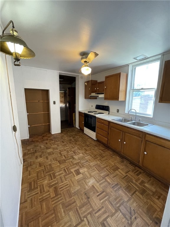 kitchen featuring white electric stove, ceiling fan, dark parquet floors, and sink