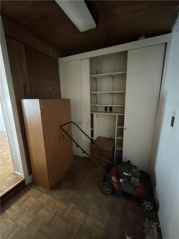 laundry room featuring parquet flooring