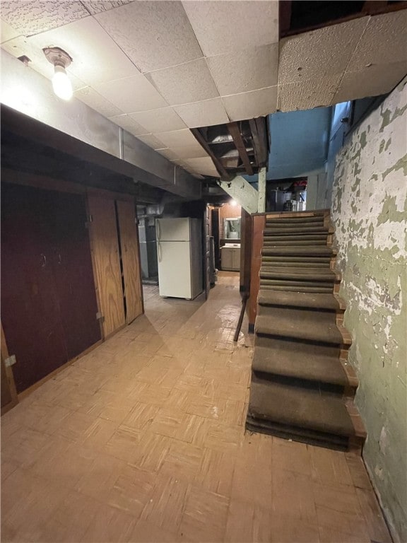 basement featuring white refrigerator