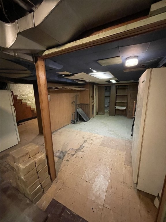 basement with white refrigerator