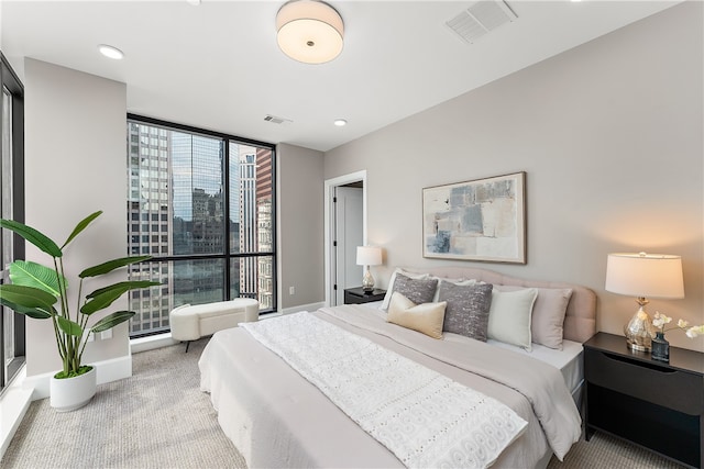 carpeted bedroom featuring expansive windows