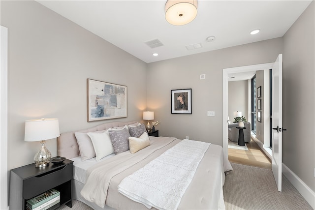 bedroom featuring light carpet